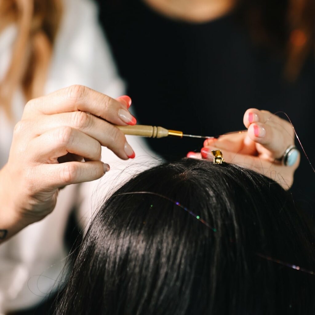 Stylists applying Goddess Glitter to hair